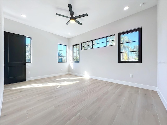 empty room featuring ceiling fan and light wood-type flooring