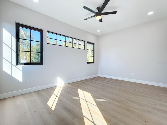 empty room featuring ceiling fan and light hardwood / wood-style flooring