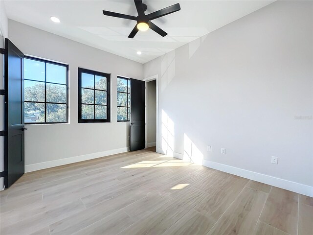 empty room featuring ceiling fan and light hardwood / wood-style floors