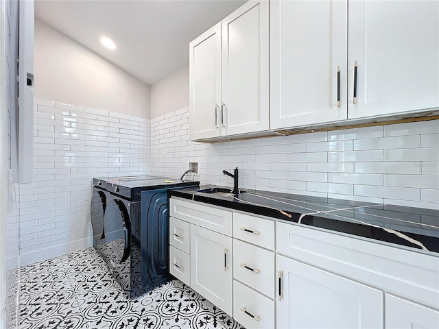 laundry area featuring sink, washer hookup, and cabinets