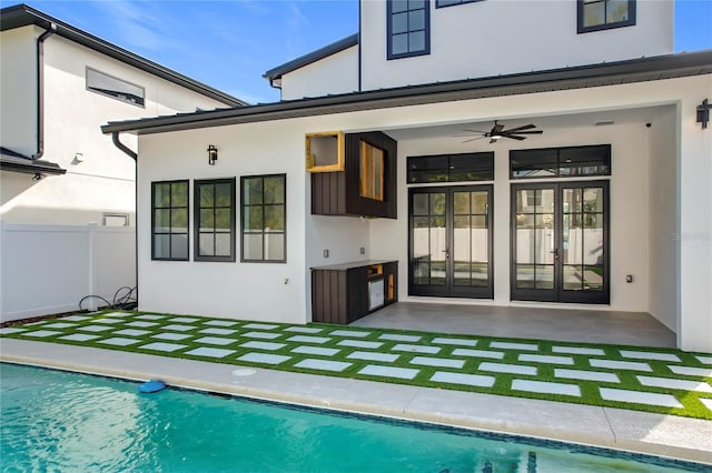 rear view of property with ceiling fan, french doors, and a patio area