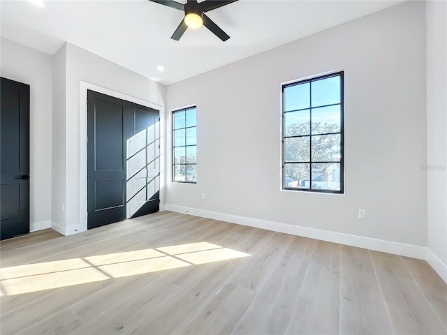 unfurnished bedroom with ceiling fan, a closet, and light hardwood / wood-style floors