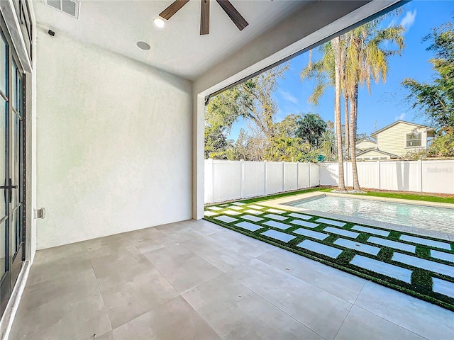 unfurnished sunroom with ceiling fan