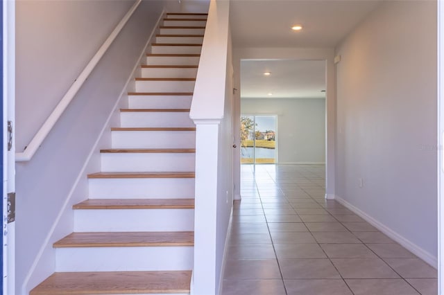 staircase featuring tile patterned flooring