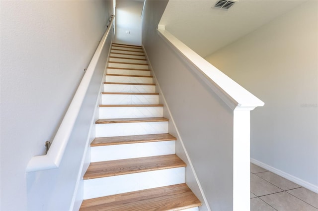 stairs with tile patterned flooring