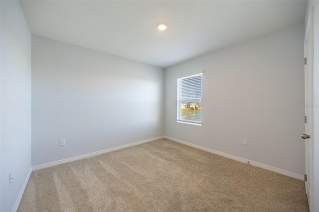 unfurnished room with light carpet