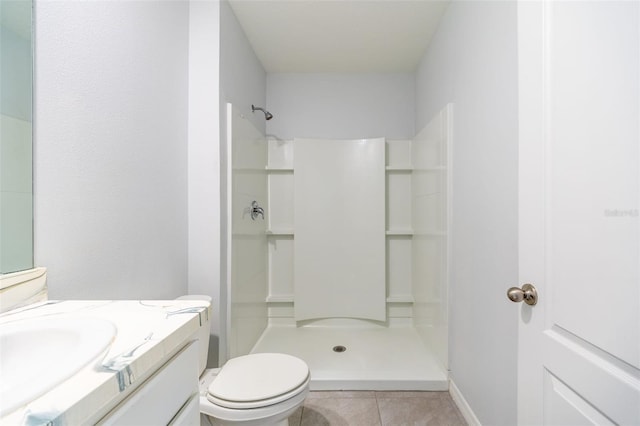 bathroom with a shower, tile patterned flooring, vanity, and toilet