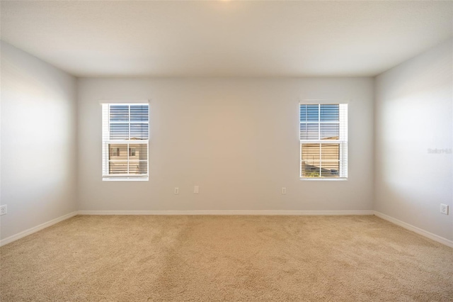 carpeted empty room with plenty of natural light