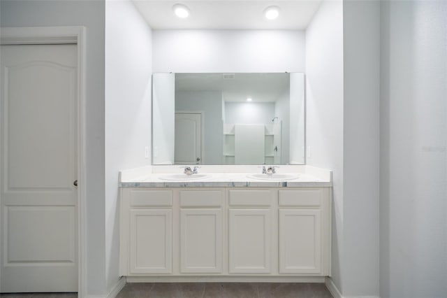 bathroom featuring tile patterned floors, vanity, and walk in shower