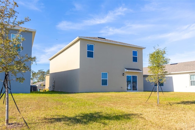 rear view of house with a lawn