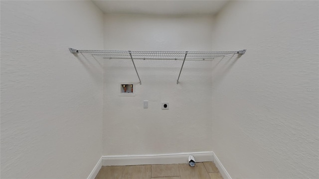 clothes washing area featuring electric dryer hookup, hardwood / wood-style floors, and washer hookup