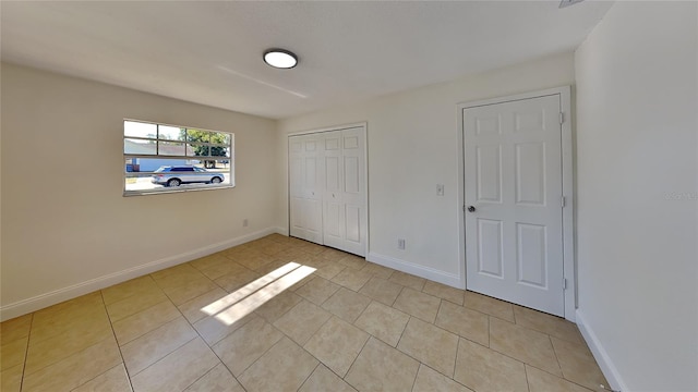 unfurnished bedroom featuring light tile patterned floors