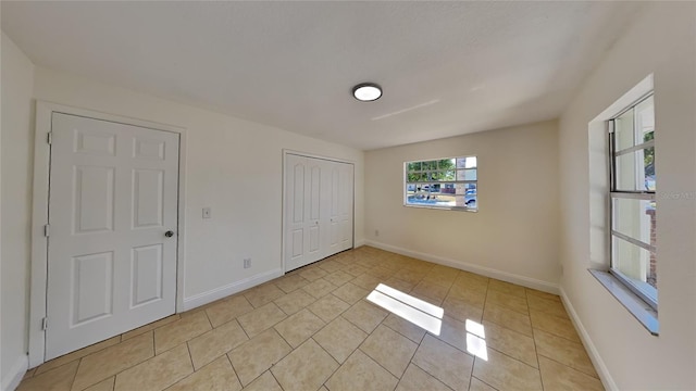 unfurnished bedroom featuring light tile patterned flooring