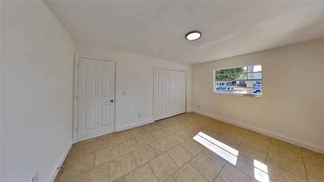 unfurnished bedroom featuring light tile patterned flooring