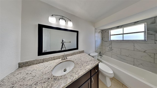 full bathroom featuring vanity, tile patterned floors, tiled shower / bath combo, and toilet