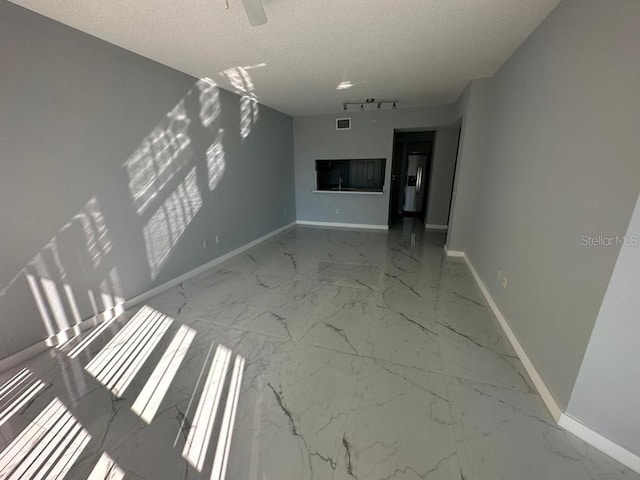 unfurnished living room featuring a textured ceiling