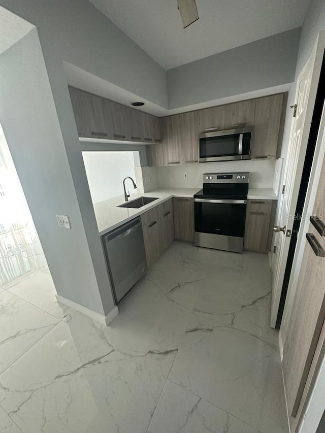 kitchen with sink, light brown cabinets, and appliances with stainless steel finishes