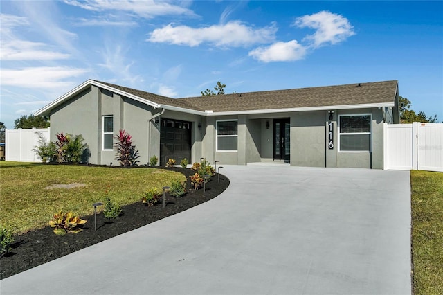 ranch-style home with a front yard and a garage