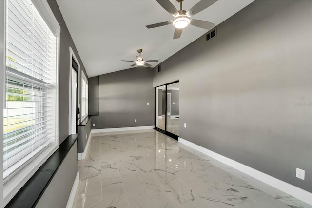 unfurnished room with ceiling fan and vaulted ceiling