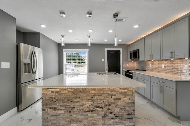 kitchen with stainless steel appliances, gray cabinetry, and sink