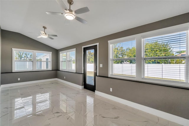 spare room featuring ceiling fan, a healthy amount of sunlight, and vaulted ceiling