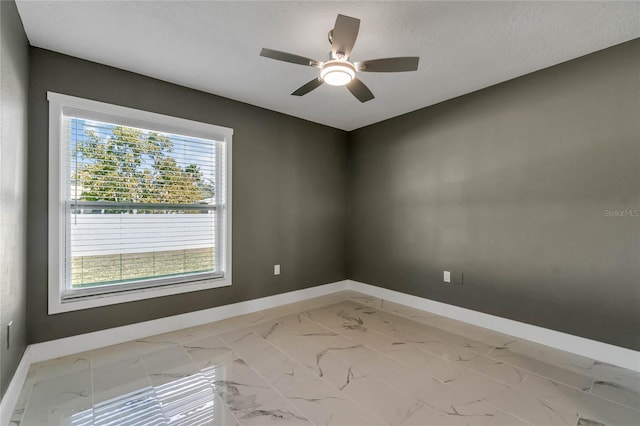 unfurnished room featuring ceiling fan and a textured ceiling