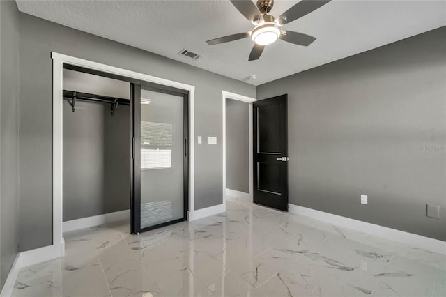 unfurnished bedroom featuring ceiling fan, a closet, and a textured ceiling