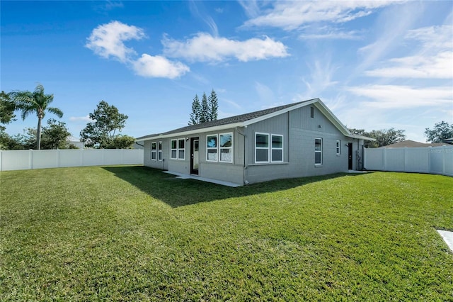 rear view of property with a lawn