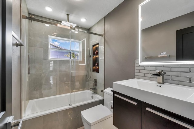 full bathroom featuring vanity, toilet, and enclosed tub / shower combo