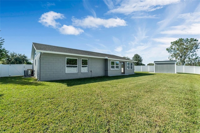 back of property featuring a lawn, a storage unit, and central air condition unit