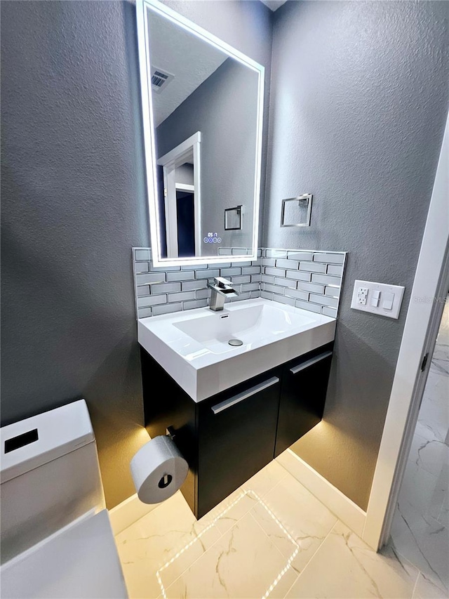 bathroom with vanity and backsplash