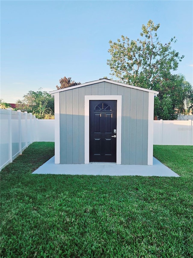 view of outbuilding featuring a yard