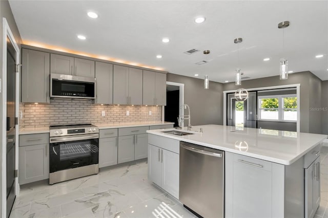 kitchen with gray cabinets, sink, and appliances with stainless steel finishes