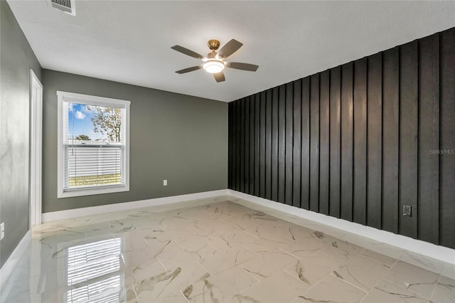 spare room with a textured ceiling and ceiling fan