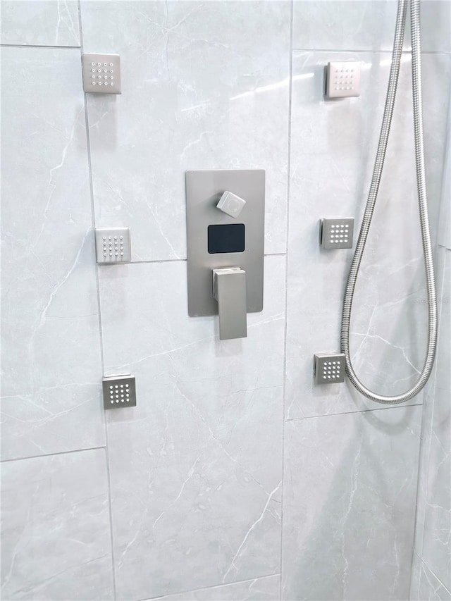 bathroom with tiled shower