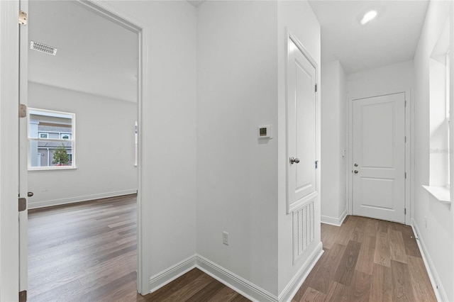 hallway with hardwood / wood-style floors