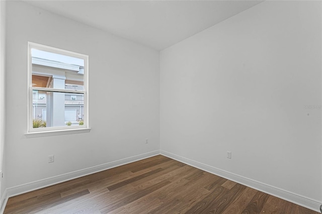 spare room with dark wood-type flooring