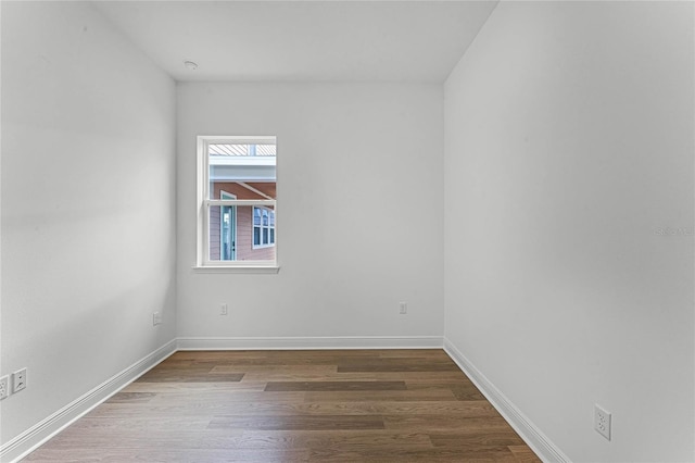 unfurnished room with hardwood / wood-style flooring