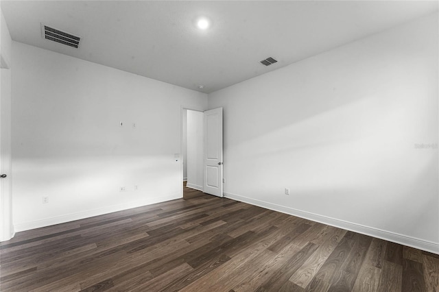 empty room featuring dark hardwood / wood-style flooring