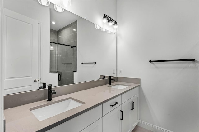 bathroom featuring vanity and a shower with shower door