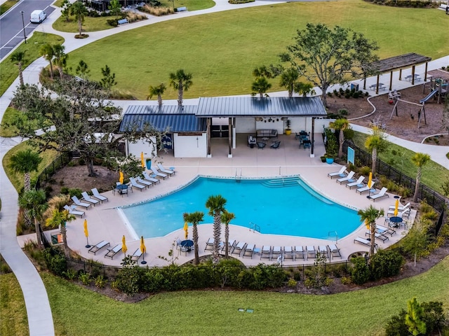 view of pool with a lawn and a patio