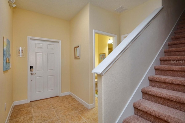 entrance foyer with light tile patterned floors