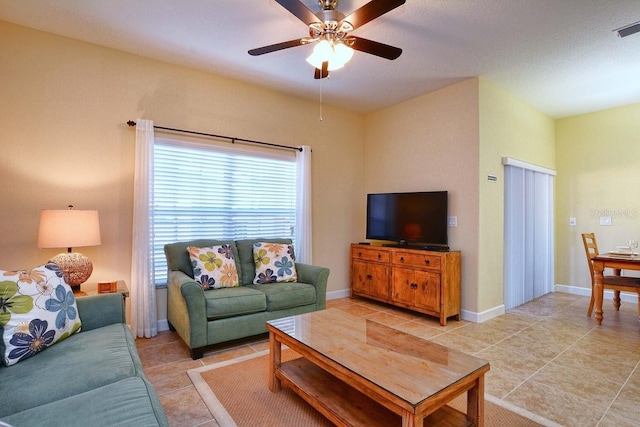 tiled living room featuring ceiling fan