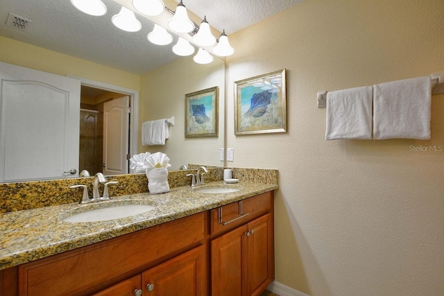 bathroom featuring vanity and a textured ceiling