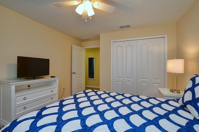 unfurnished bedroom with a textured ceiling, a closet, and ceiling fan