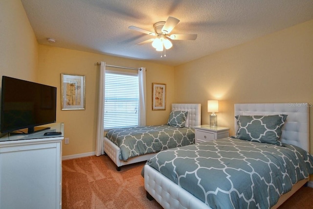 carpeted bedroom featuring ceiling fan and a textured ceiling