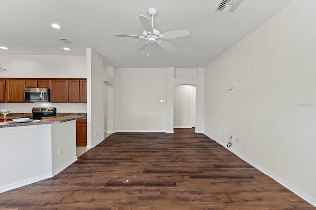 kitchen featuring appliances with stainless steel finishes, dark wood-type flooring, a textured ceiling, and ceiling fan