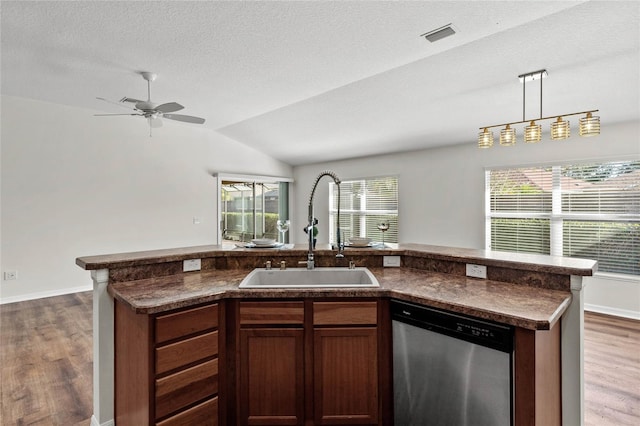 kitchen with pendant lighting, sink, stainless steel dishwasher, and dark wood-type flooring