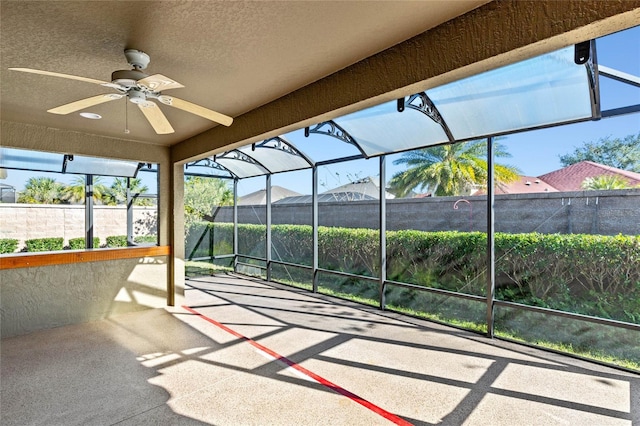 exterior space with ceiling fan and glass enclosure