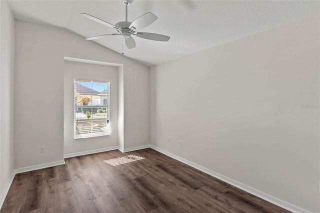 unfurnished room featuring lofted ceiling, dark hardwood / wood-style flooring, and ceiling fan